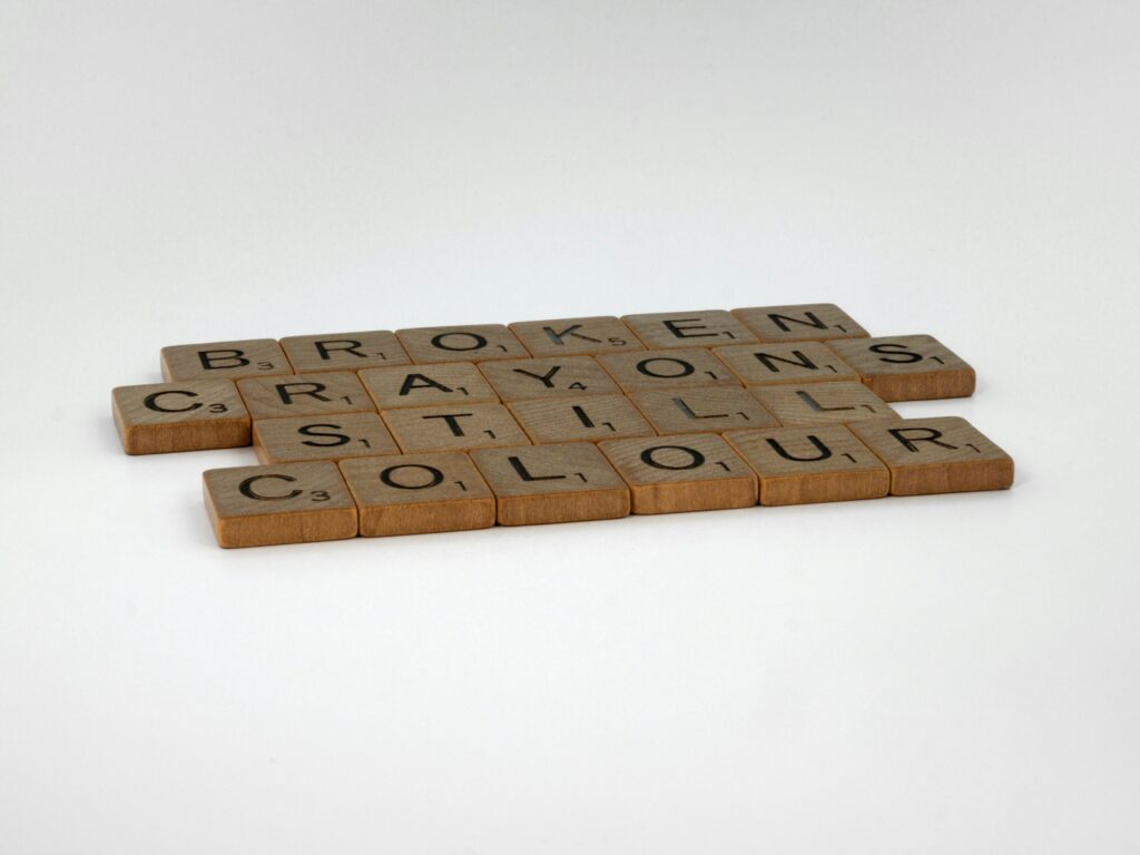Image of Scrabble tiles spelling 'Broken Crayons Still Colour' on white background, promoting creativity. for a blog post about self-worth and comparison.